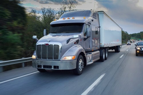 Tractor Trailer on busy country highway with other cars